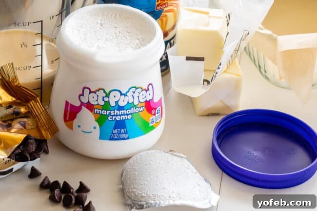 Mom's Effortless Fudge 12 A tub of Jet-Puffed marshmallow creme with the lid and foil seal completely removed, ready for use in fudge preparation.