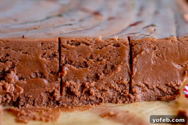 Mom's Effortless Fudge 5 A close-up shot of marshmallow fluff fudge with scoring marks, indicating it's ready to be cut into perfect squares.