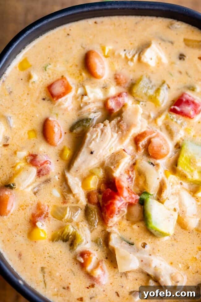 Effortless Creamy White Chicken Chili 6 Close-up shot of the best white chicken chili in a black bowl, showcasing its rich and creamy texture.