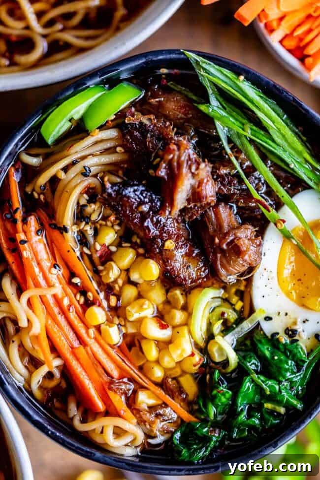 Slow Cooker Pork Ramen Deep Flavor Zero Fuss 2 pork ramen in a black bowl with garnishes: carrots, egg, spinach, green onions