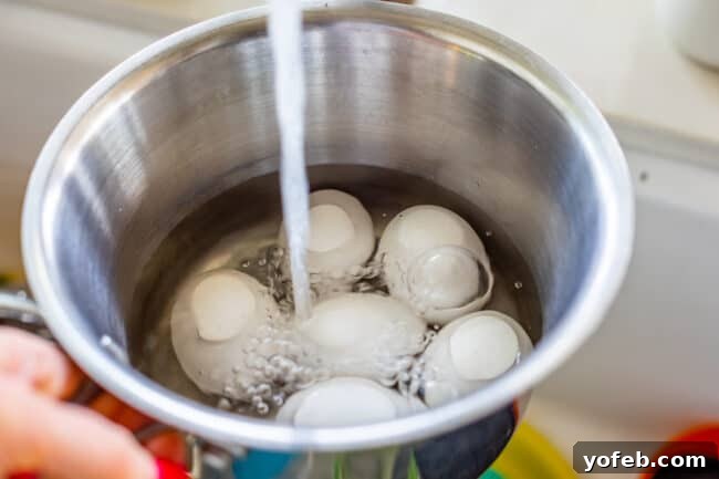 Slow Cooker Pork Ramen Deep Flavor Zero Fuss 13 adding water from a faucet into a pot with eggs