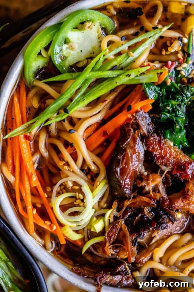 Slow Cooker Pork Ramen Deep Flavor Zero Fuss 23 pork ramen noodles with green onions and jalapenos in a bowl