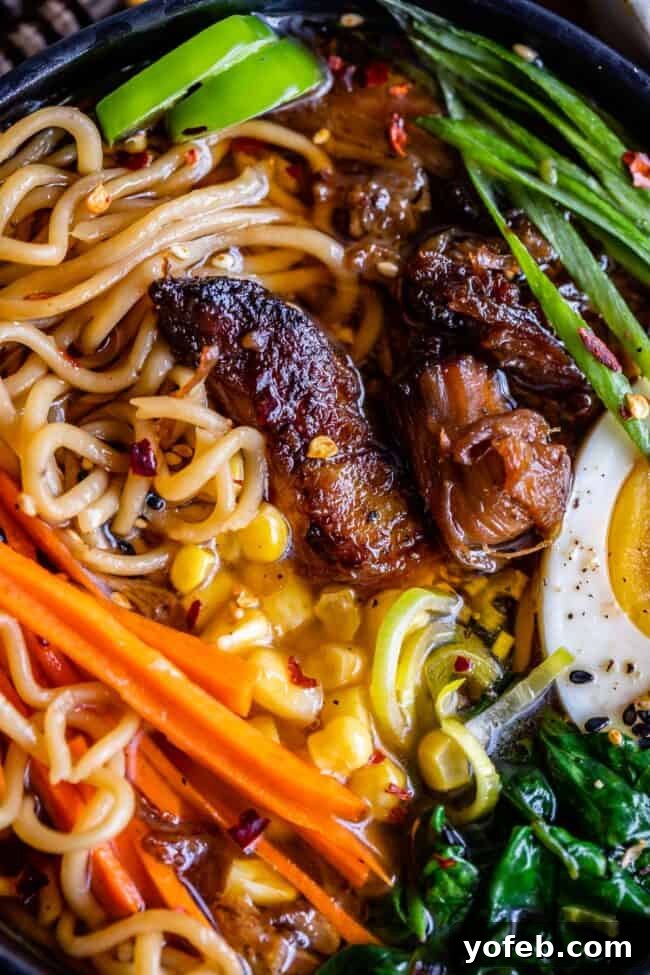 Slow Cooker Pork Ramen Deep Flavor Zero Fuss 6 closeup shot of pork ramen noodles, broth, corn, carrots, pork, egg, etc.