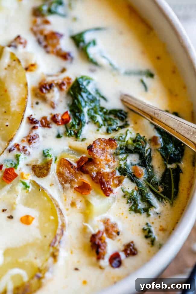 Olive Garden Zuppa Toscana at Home A close-up of Olive Garden style Zuppa Toscana in a white bowl, showcasing the creamy broth, sausage, and kale.