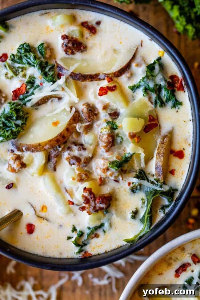 Hearty Zuppa Toscana Soup on a Wooden Table A black bowl filled with rich Zuppa Toscana, served on a rustic wooden table.