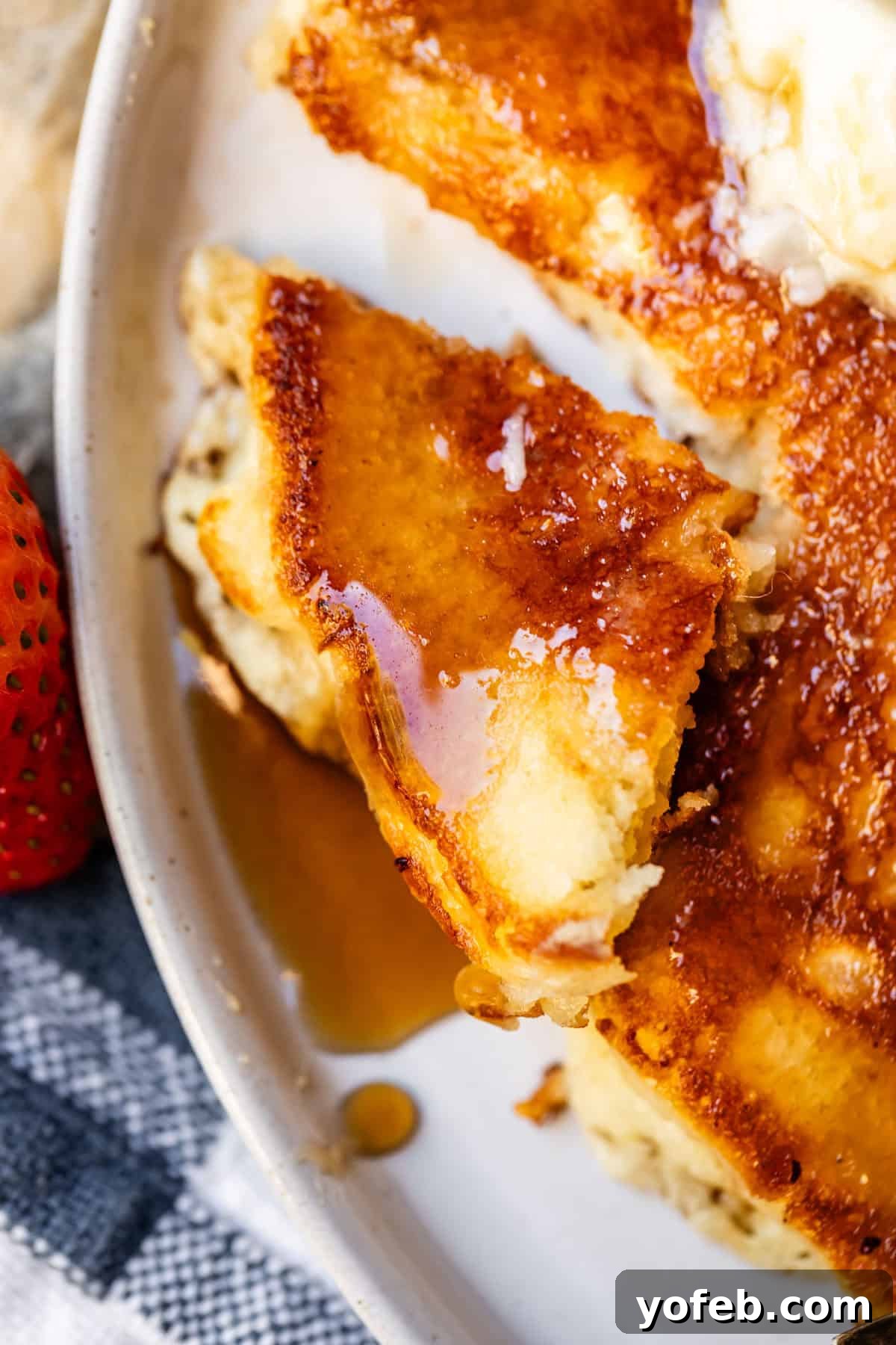 Effortless Homemade Maple Syrup 11 A perfectly cut piece of homemade pancake adorned with a melting pat of butter and golden syrup, ready to be savored.
