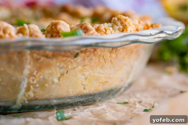 Effortless Bacon and Spinach Quiche 11 The side view of a clear glass pie pan reveals the perfectly browned and crisp crust of a spinach quiche recipe, baked to perfection.
