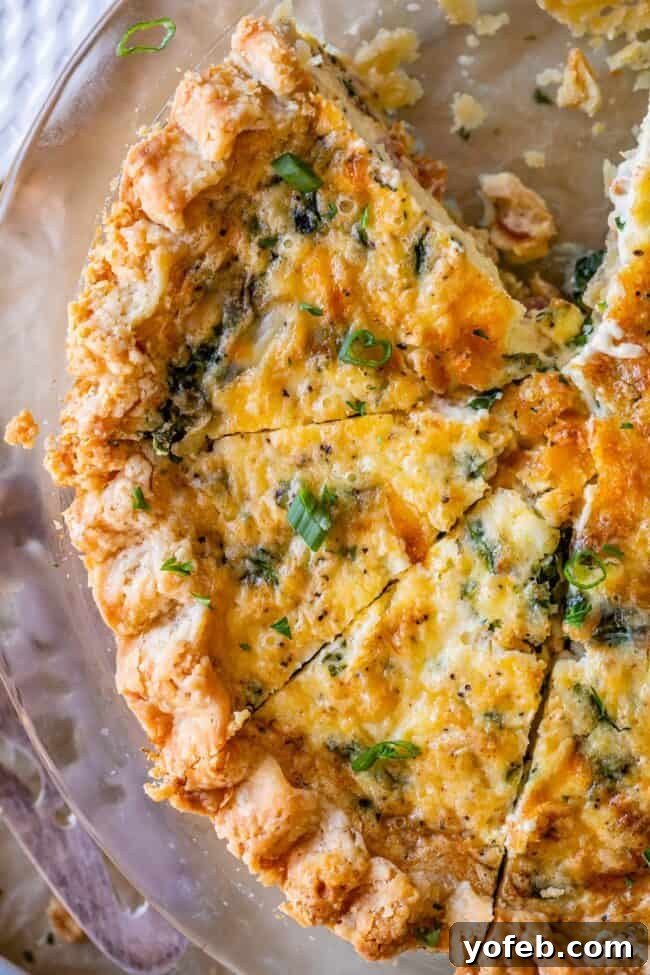 Effortless Bacon and Spinach Quiche 21 An overhead shot captures a perfectly baked quiche recipe, richly adorned with cheese and bacon, glistening and golden.
