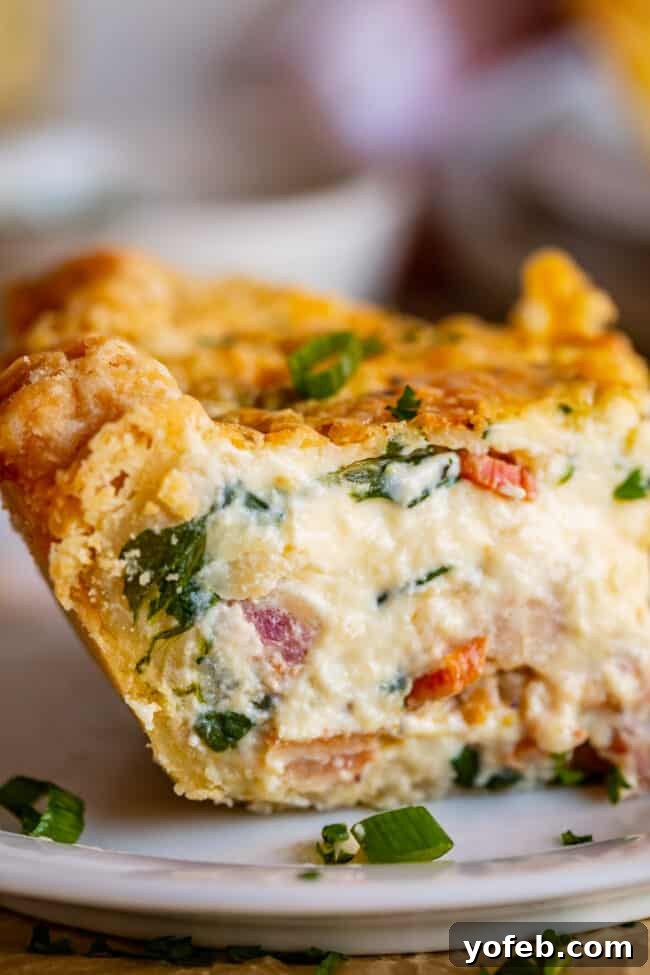 Effortless Bacon and Spinach Quiche 7 A perfect cross-section of a baked quiche, revealing its layers of savory filling and a crisp, golden crust.