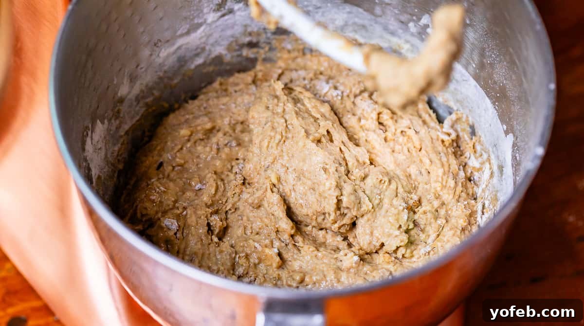 Grandma Prudy's Heirloom Rye Loaf 15 Sticky, wet rye bread dough in a stand mixer, demonstrating the expected consistency.