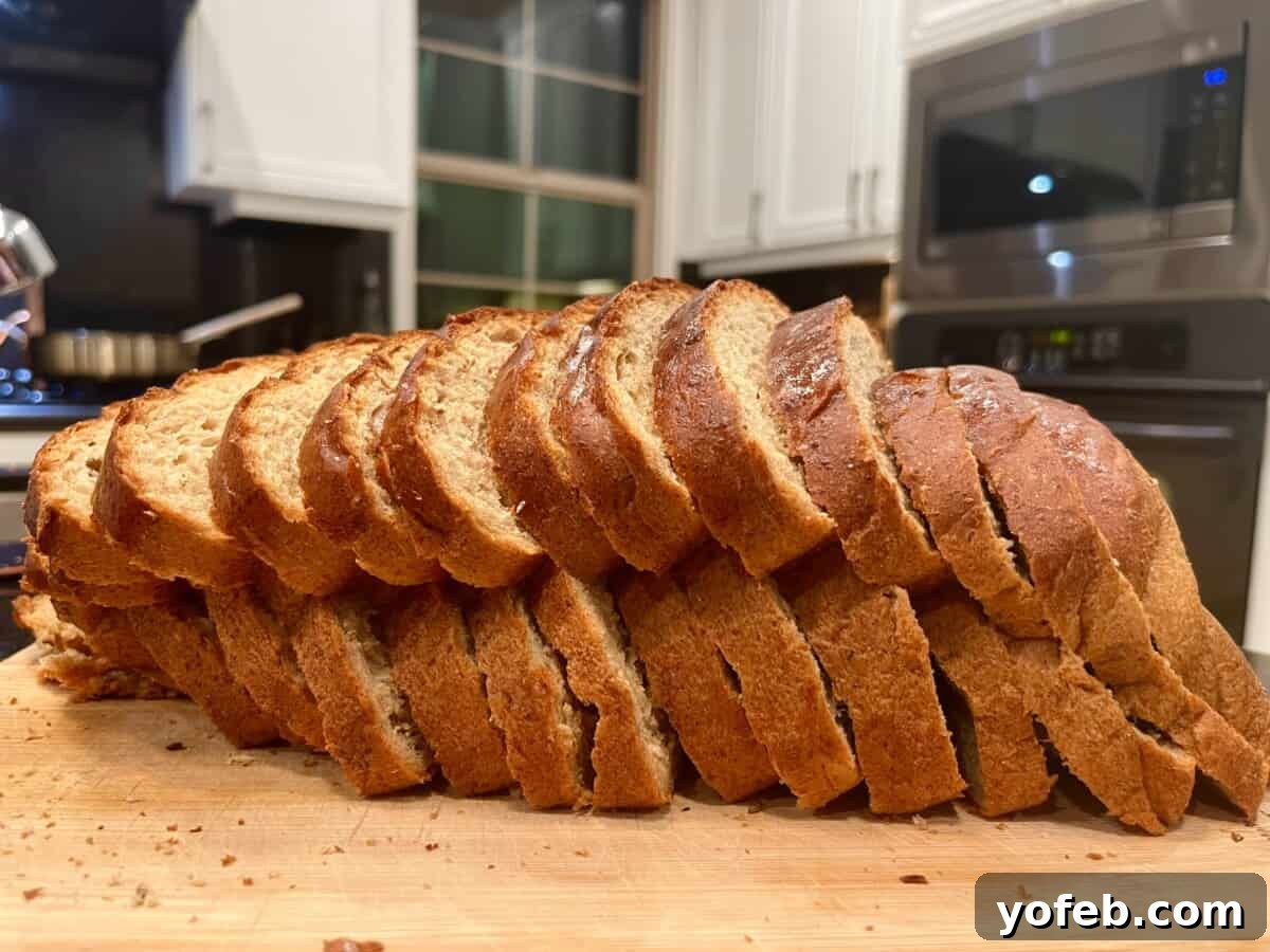 Grandma Prudy's Heirloom Rye Loaf 7 A perfectly sliced loaf of Swedish rye bread on a wooden cutting board, revealing its soft crumb.