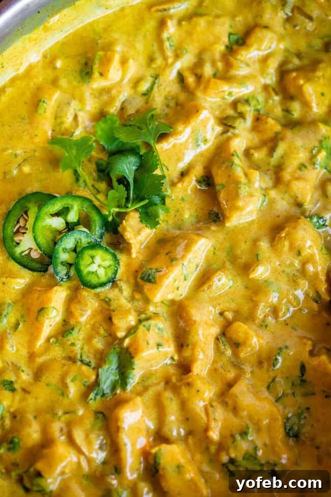 Flavorful Chicken Curry Made Easy 18 close up of Indian chicken curry recipe in a pan with jalapeno.