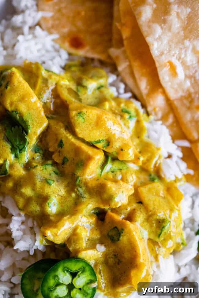 Flavorful Chicken Curry Made Easy 5 easy curry recipe placed on rice with roti in the background.