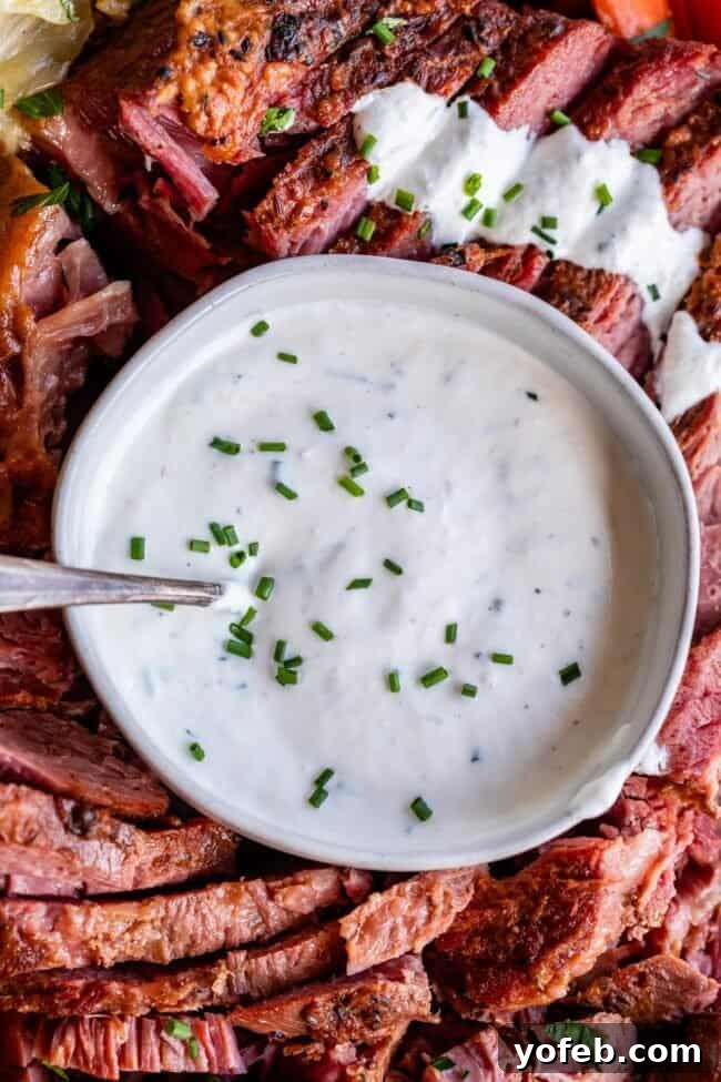Fiery Homemade Horseradish Sauce 2 white bowl full of creamy horseradish sauce surrounded by corned beef.