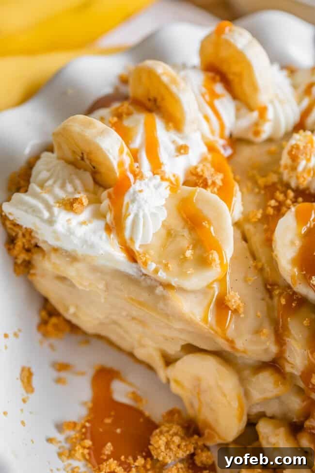 Luscious Banana Cream Pie Recipe 20 An overhead shot of a slice of banana cream pie, generously drizzled with golden caramel sauce, highlighting its rich and inviting presentation.