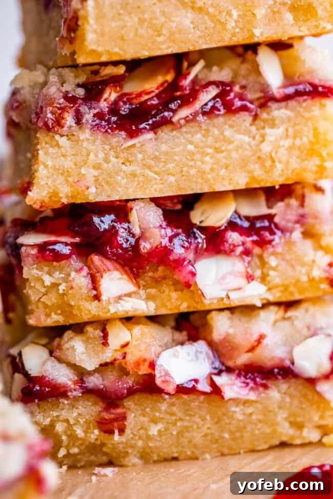 Almond Streusel Raspberry Crumb Bars 16 A beautiful stack of raspberry crumb bars, glistening with jam and almonds, ready to be enjoyed.