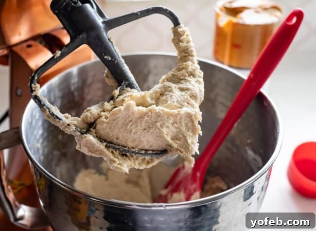 The Ultimate Peanut Butter Butterfinger Cookie 11 Butter and granulated sugar being thoroughly mixed together in a stand mixer, creating a creamy and light base for the cookie dough. This initial step is vital for achieving the perfect cookie texture.