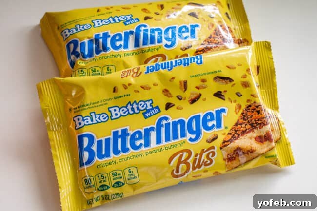 The Ultimate Peanut Butter Butterfinger Cookie 9 Two bags of Butterfinger Baking Bits displayed prominently on a clean white counter, ready to be incorporated into a delicious cookie recipe. This image clarifies the specific product used for the recipe.