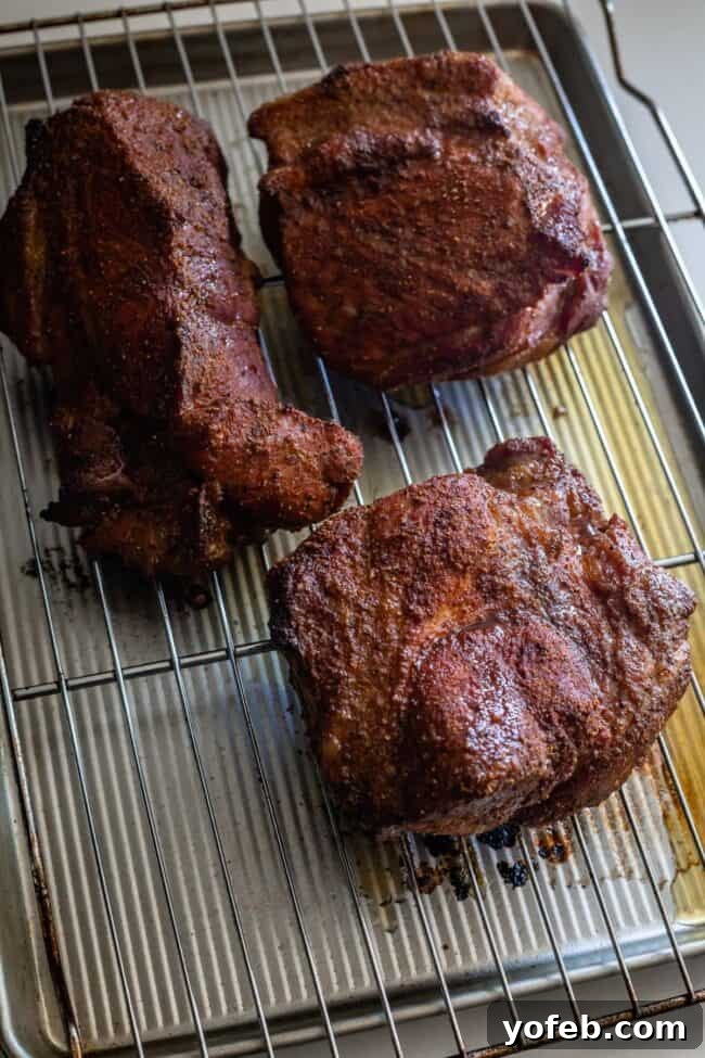 Melt In Your Mouth Pulled Pork Slow Cooker Or Oven 16 half cooked pork shoulder on a wire rack.