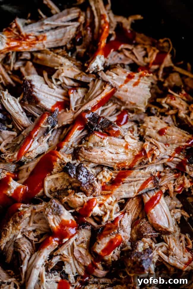 Melt In Your Mouth Pulled Pork Slow Cooker Or Oven 23 slow cooker pulled pork shredded and topped with bbq sauce.