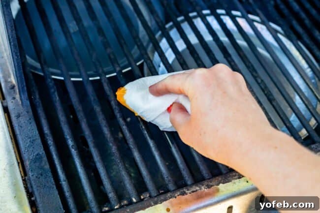 Smoky Perfection: The Ultimate Pulled Pork 18 using a crumpled paper towel to oil the grates of a grill.