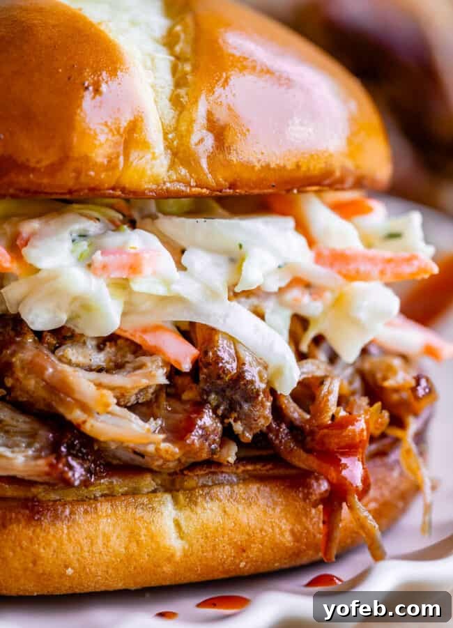 Smoky Perfection: The Ultimate Pulled Pork 3 close up of bbq smoked pulled pork sandwich with coleslaw.