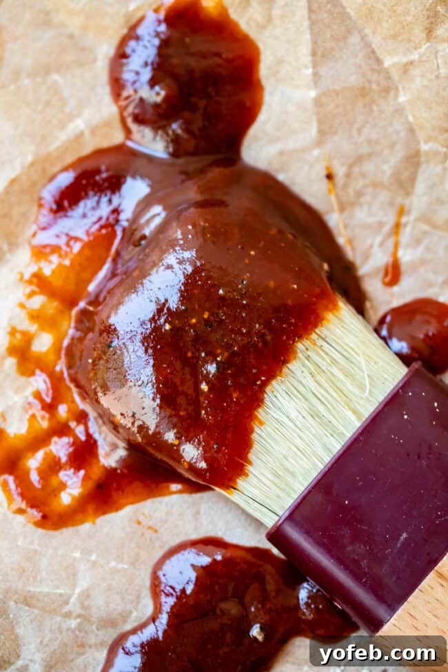 Effortless Homemade Barbecue 2 close up of easy bbq sauce on a white brush on parchment paper.