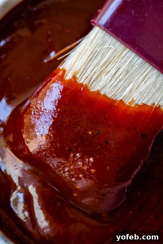 Effortless Homemade Barbecue 14 white brush being dipped into bowl of homemade barbecue sauce.