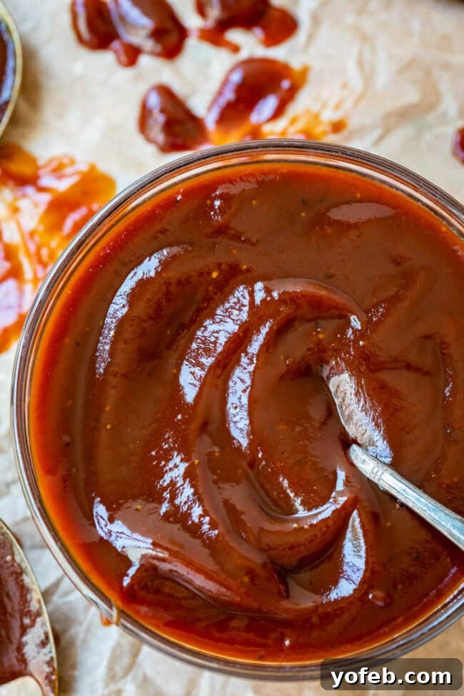 Effortless Homemade Barbecue 15 overhead shot of easy bbq sauce in a clear glass bowl on parchment paper.