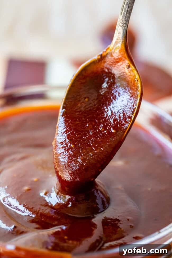 Effortless Homemade Barbecue 6 spoon lifting homemade barbecue sauce from a bowl of sauce.