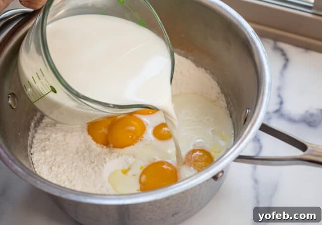 Sunshine Lemon Delight 8 Pouring milk into a mixture for dessert crust, likely a different recipe, but used to illustrate mixing.