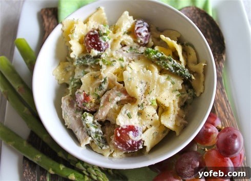 A vibrant Lemon Tarragon Pasta Salad featuring tender chicken and fresh grapes, ready to serve.
