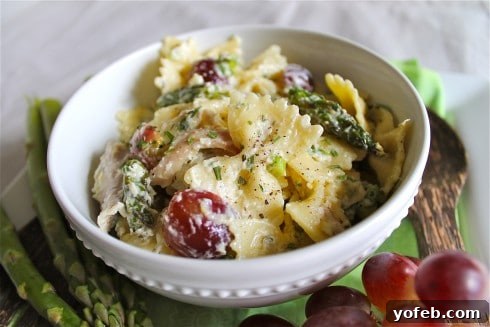 Close-up of Lemon Tarragon Pasta Salad with fresh asparagus and bow tie pasta.