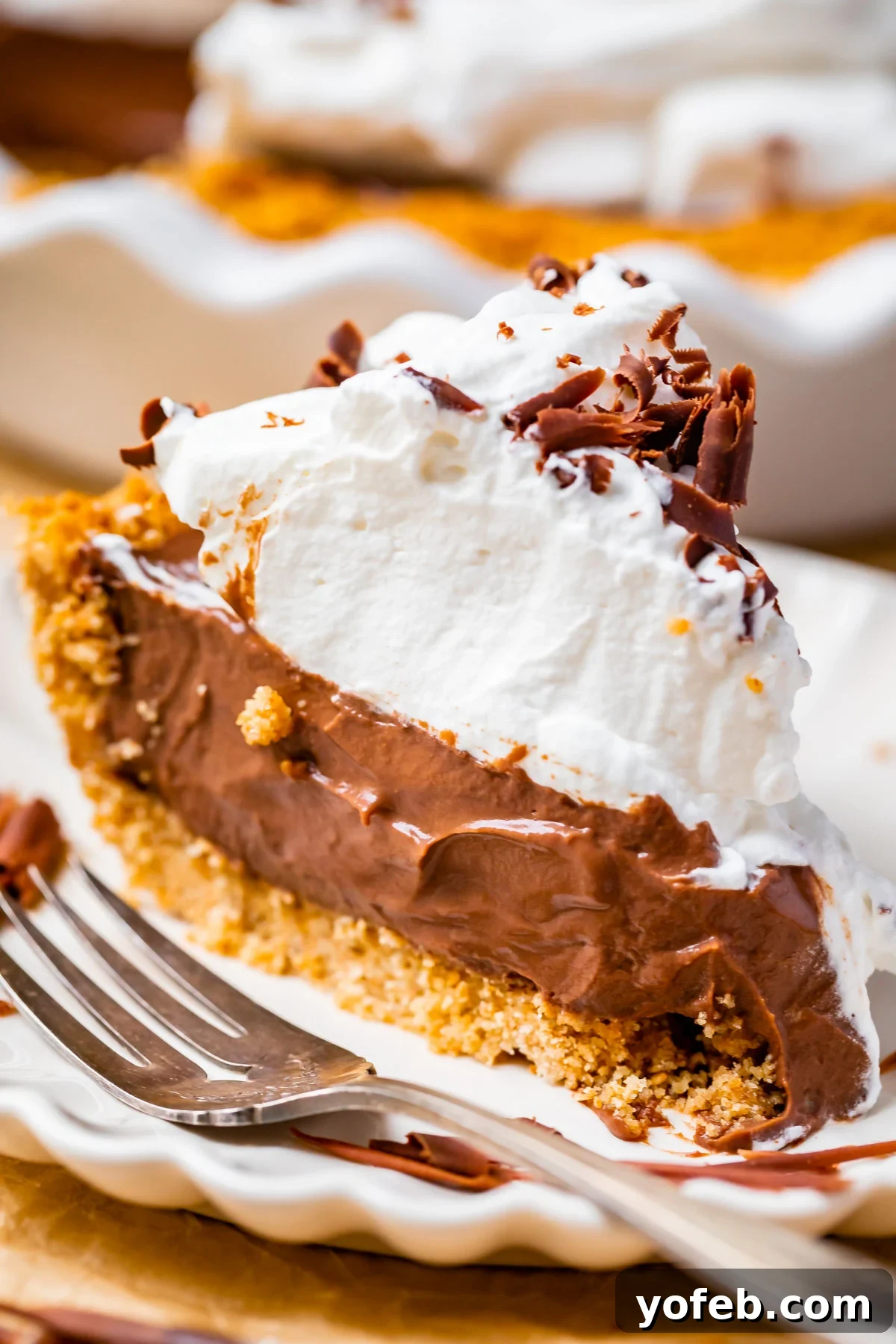 Decadent Chocolate Cream Pie Perfection 2 A slice of the best chocolate cream pie recipe on a white plate with a fork, showing its rich layers and creamy texture.
