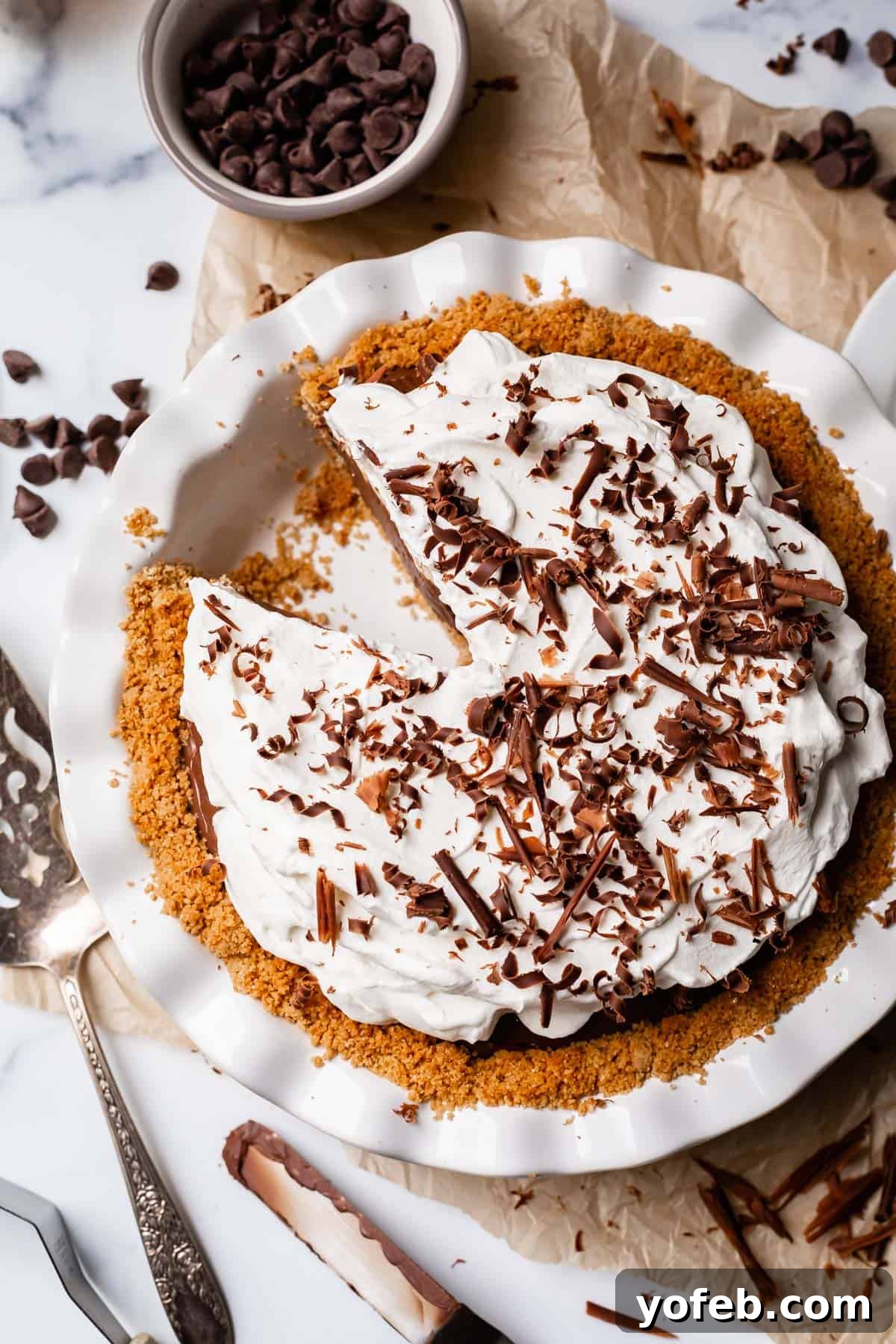 Decadent Chocolate Cream Pie Perfection 4 An overhead shot of a freshly made chocolate cream pie with a golden graham cracker crust, topped with creamy pudding.