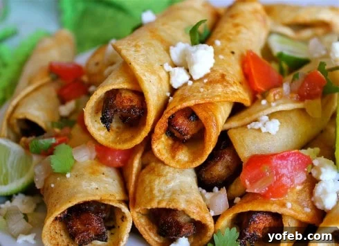 Chicken Flautas by The Food Charlatan. These deliciously crispy chicken flautas are so satisfying! What's not to love about seasoned chicken breast rolled up in little tortillas and fried? Top them with pico de gallo, sour cream, and queso fresco for an unforgettable Mexican feast. #fried #chicken #flauta #Mexican #easy #authentic #picodegallo #dinner #tortillas Crispy homemade chicken flautas served with fresh pico de gallo, avocado sauce, and crumbled queso fresco.