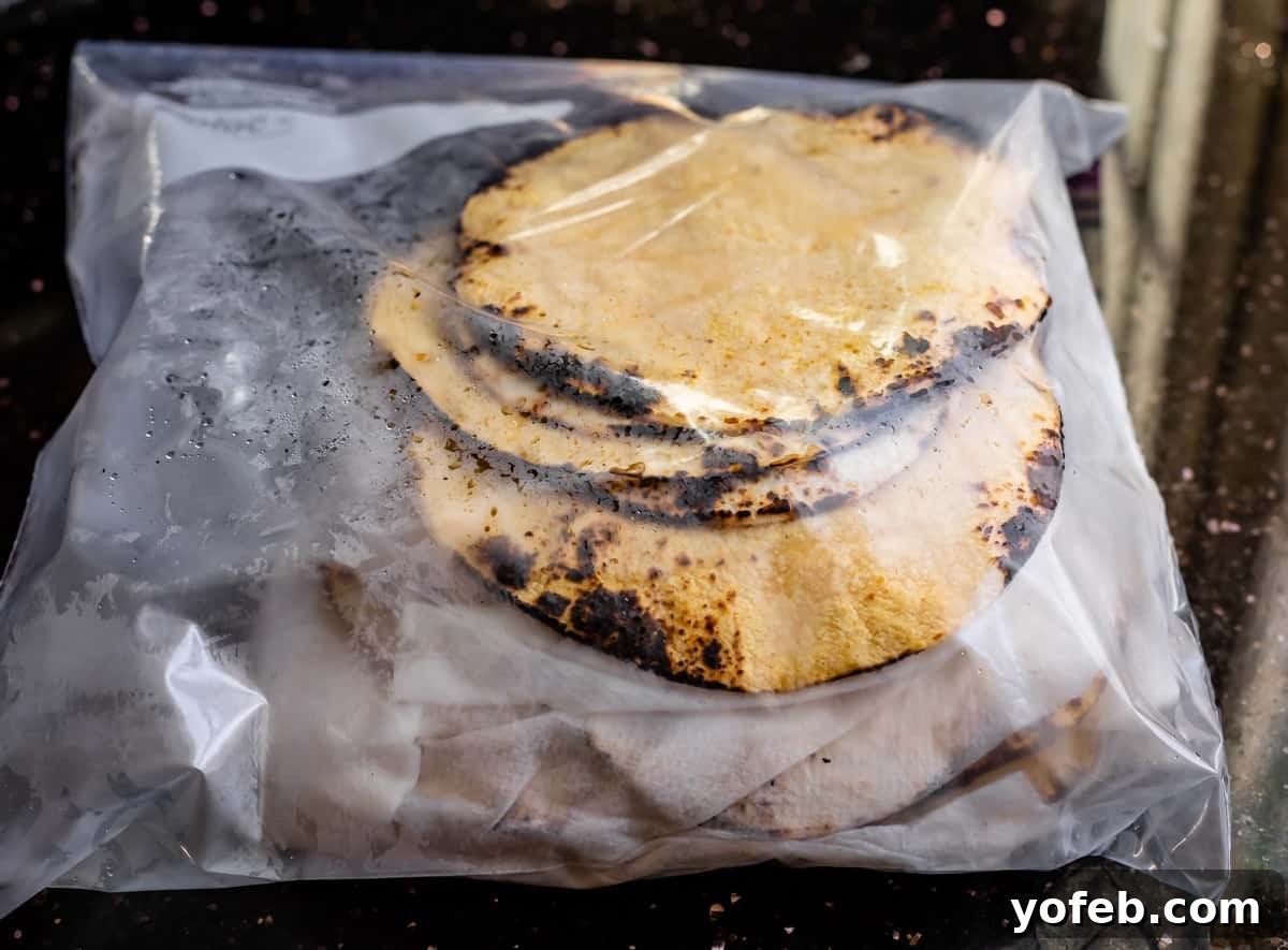 Ultimate Chicken Tacos Quick and Slow Cooker Options 17 gallon size ziplock bags with charred corn tortillas in them to keep them warm and fresh.