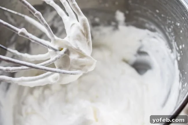 Peppermint Whipped Cream: A light and fluffy trifle layer Freshly whipped peppermint cream in a mixing bowl, ready for the trifle