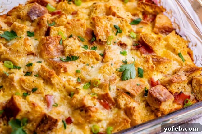 Brunch-Ready Overnight Eggs Benedict Bake 14 A freshly baked Eggs Benedict casserole garnished with vibrant parsley and green onion, ready to be served, highlighting its appealing presentation.