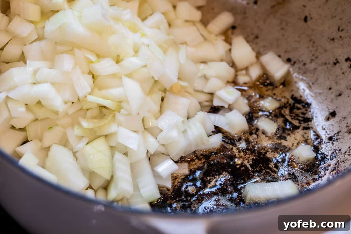 Mastering the Art of Italian Wedding Soup 15 close up of onion frying in blackened meatball drippings.