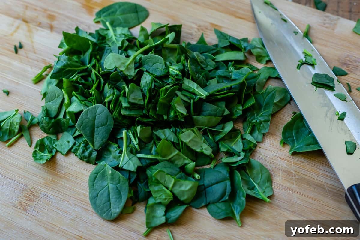 Mastering the Art of Italian Wedding Soup 20 knife and chopped spinach on a cutting board to show chop size.