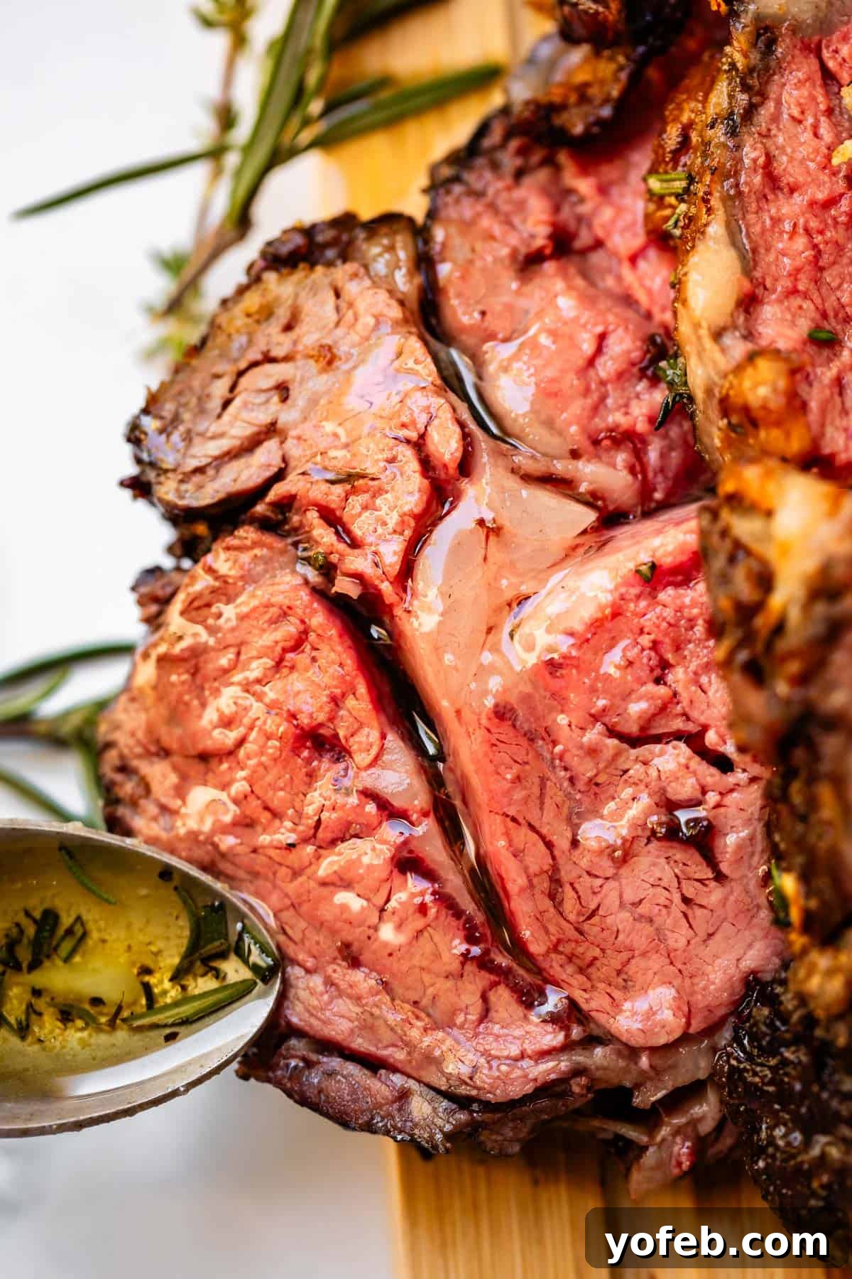 Wow Your Guests With This Perfect Prime Rib 6 A single, thick slice of perfectly cooked prime rib, generously coated in a glistening garlic and herb butter sauce.