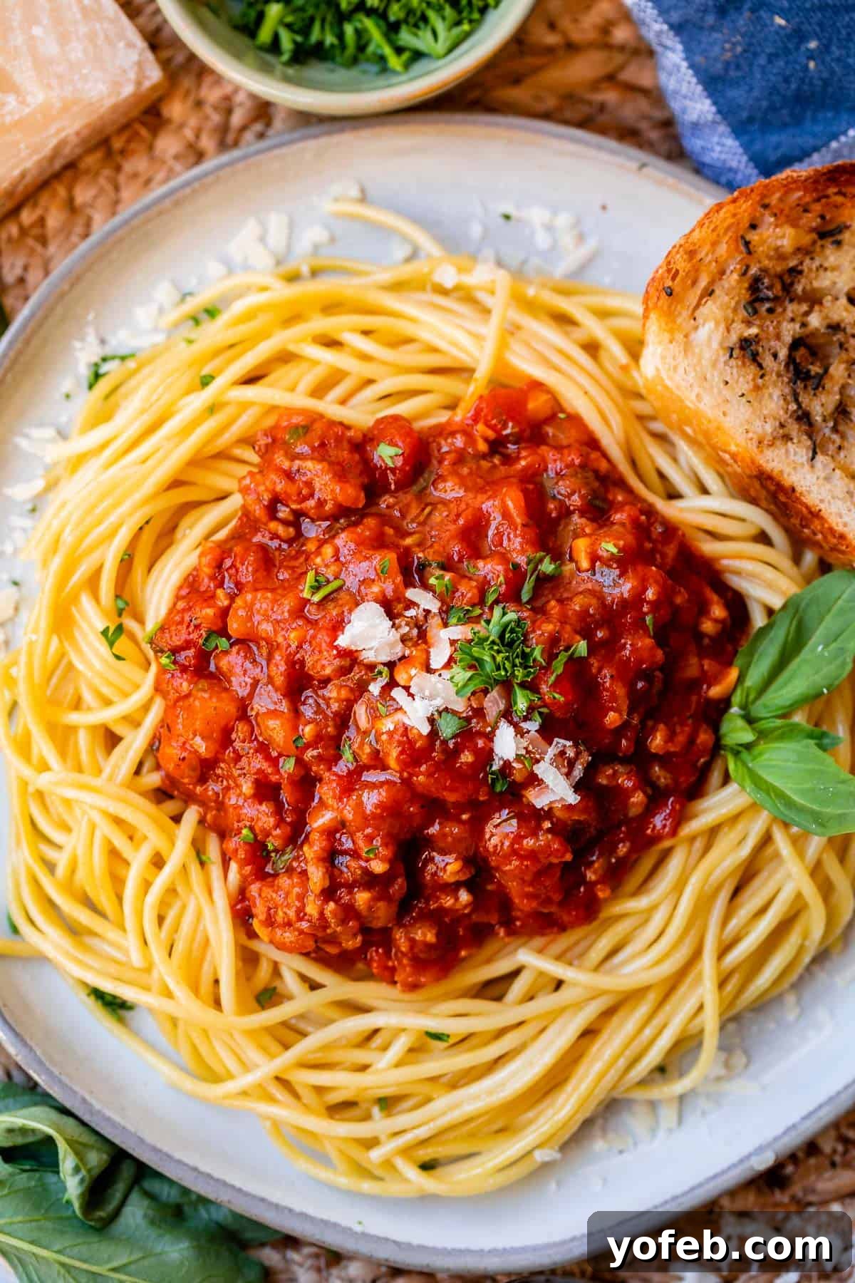 Effortless 30-Minute Spaghetti Sauce 13 An artfully arranged plate of spaghetti noodles with a neat, generous scoop of rich red meat sauce on top, ready to be enjoyed.