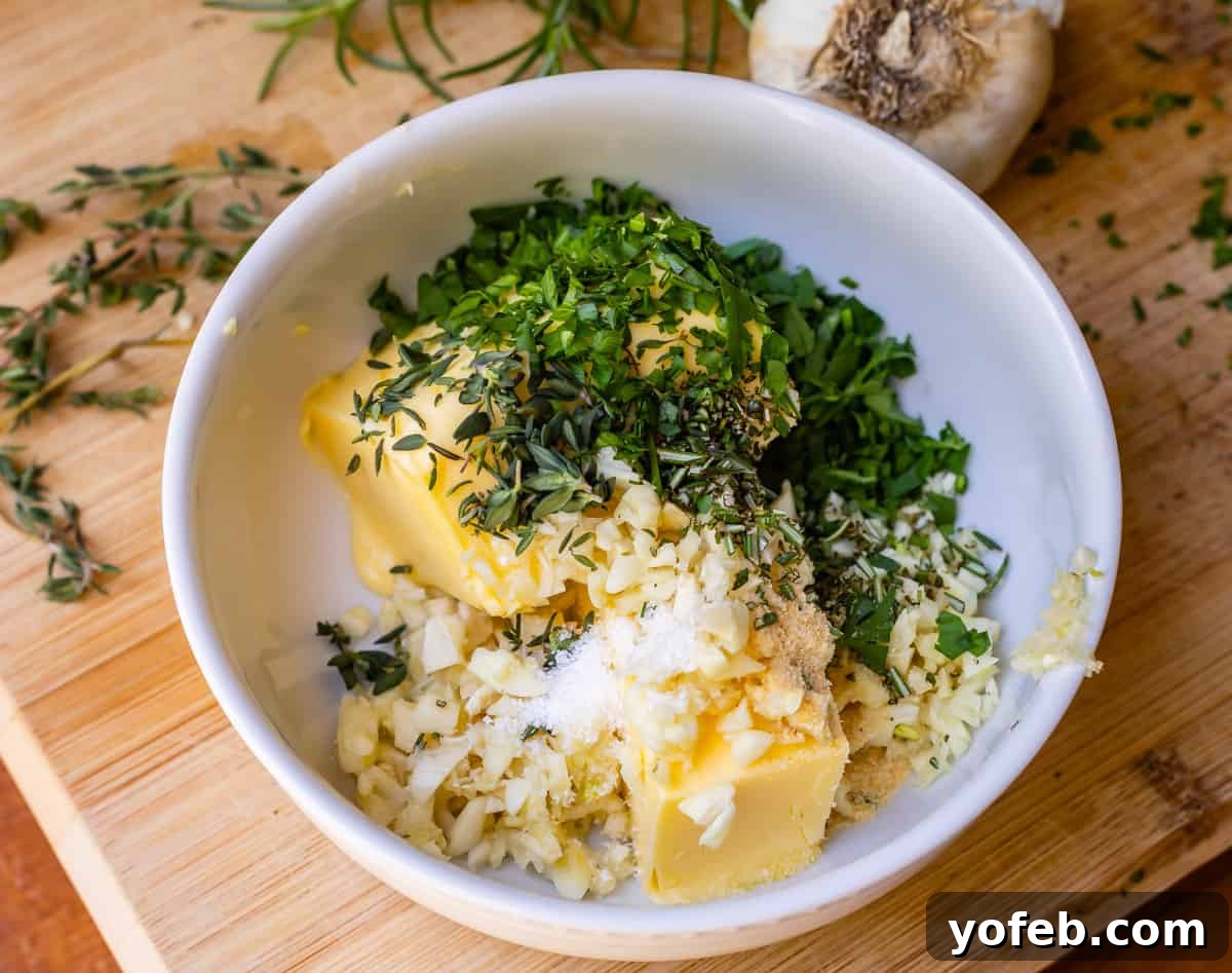 Irresistible Garlic Butter Loaf 14 Bowl containing softened butter, minced garlic, fresh parsley, and other herbs, ready to be mixed for garlic butter.