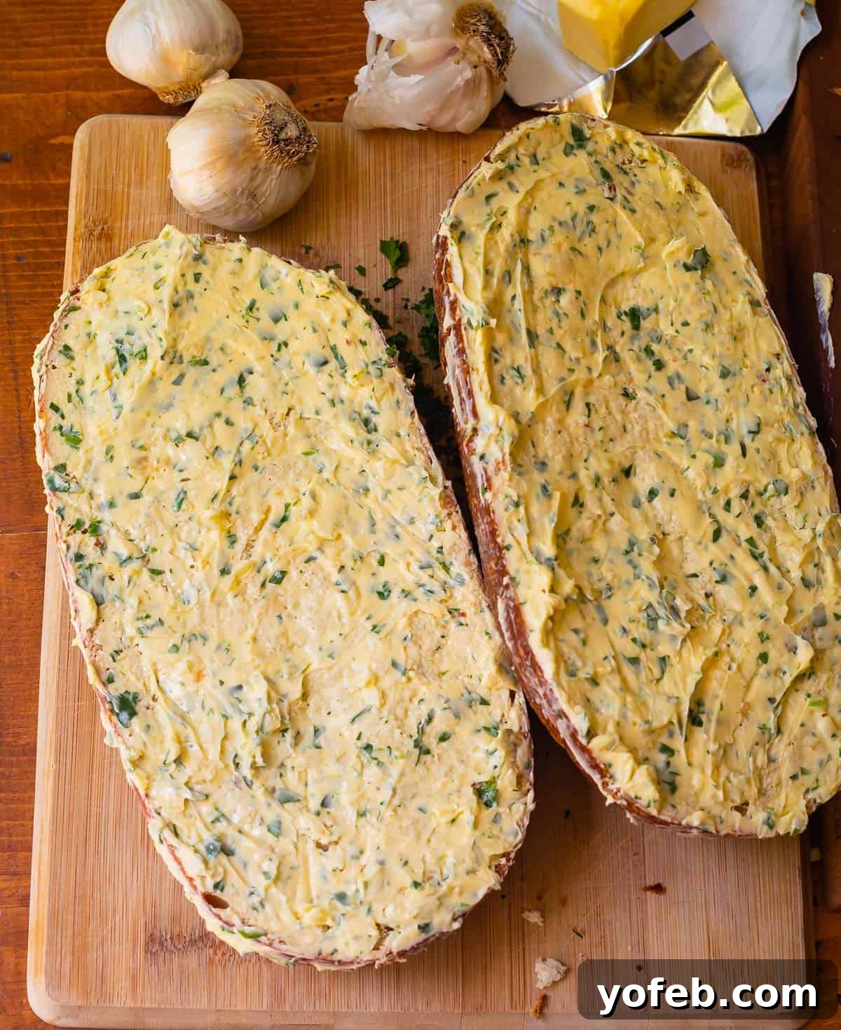 Irresistible Garlic Butter Loaf 18 Lengthwise split loaf of unbaked garlic bread, visually demonstrating the ample amount of butter to be used.