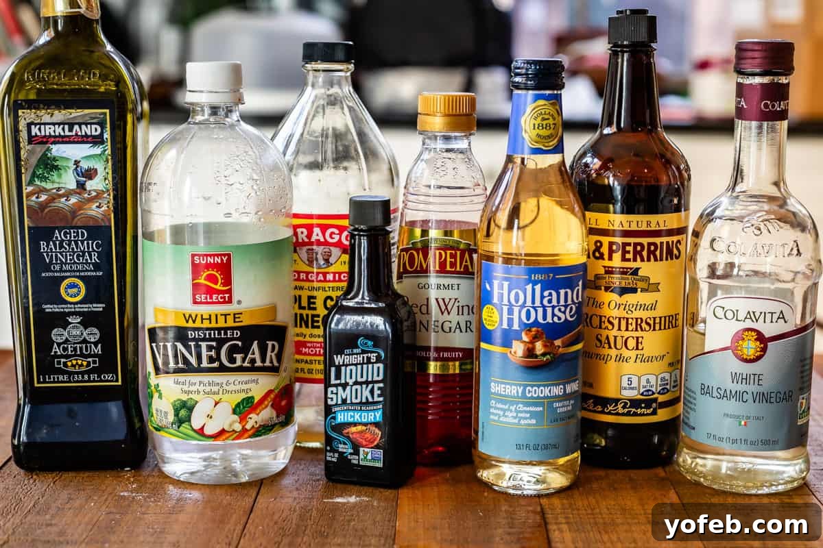 The Ultimate Guide to a Fully Stocked Pantry and Fridge 3 Bottles of vinegar, liquid smoke, cooking wine, and Worcestershire sauce neatly arranged on a rustic wooden table.