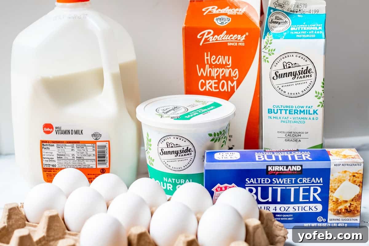 The Ultimate Guide to a Fully Stocked Pantry and Fridge 5 A selection of dairy products and eggs including milk, sour cream, whipping cream, buttermilk, butter, and eggs, arranged on a pristine white surface.