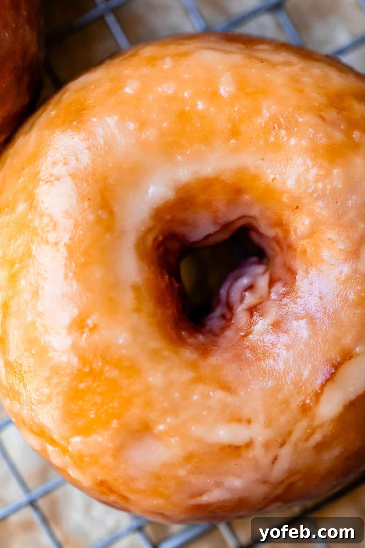 Doughnut Delights from Scratch 36 Close-up looking down at the finished product of the entire homemade donut making process, showcasing a beautifully glazed donut.