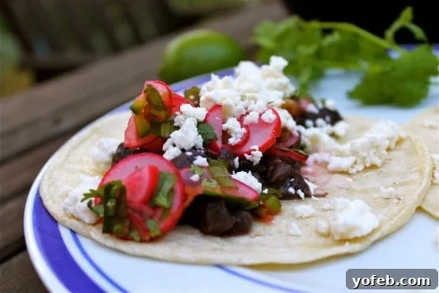 A taco with vegetables and cheese on a plate makes an easy back to school dinner.