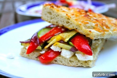 Zesty Grilled Squash, Red Pepper, and Feta Sandwich 4 Close-up of golden focaccia bread with melted feta cheese